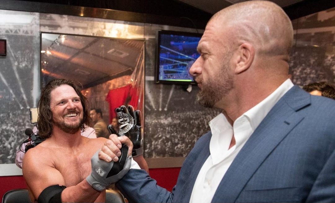 triple h congratulating aj after the latters first wwe v0